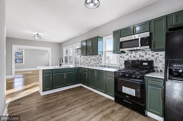 kitchen with black appliances and green cabinets