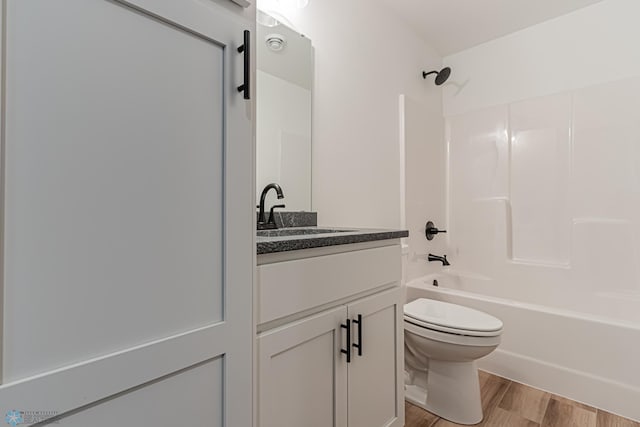 full bathroom with shower / tub combination, vanity, toilet, and hardwood / wood-style floors