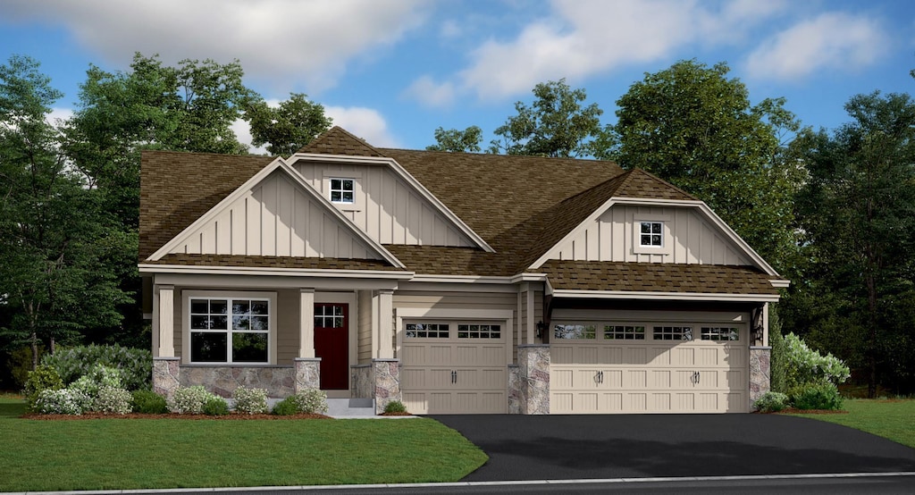 craftsman house featuring a garage and a front lawn