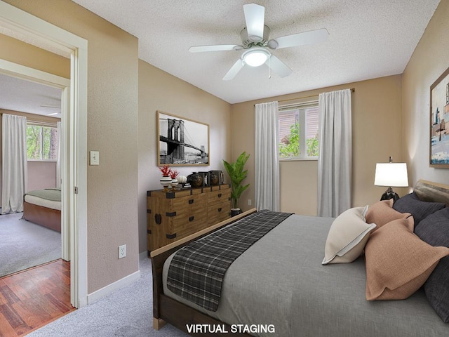 bedroom featuring hardwood / wood-style floors, a textured ceiling, and ceiling fan