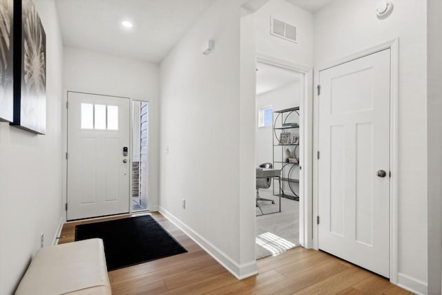 entrance foyer with plenty of natural light and light hardwood / wood-style floors