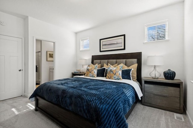 carpeted bedroom with ensuite bath