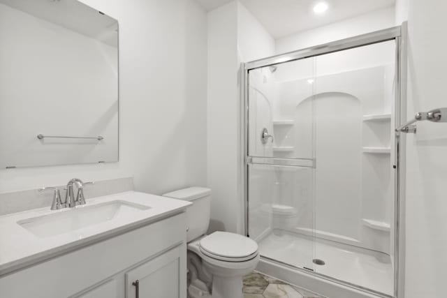 bathroom with an enclosed shower, vanity, and toilet