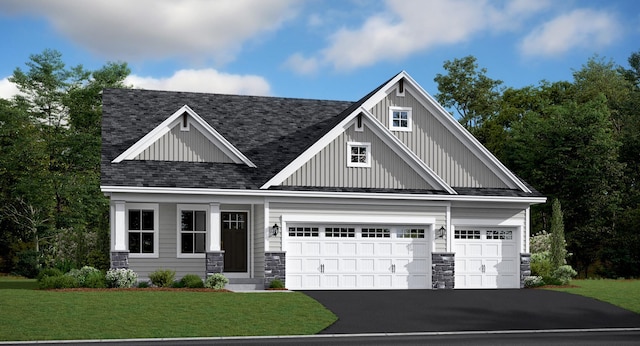 craftsman house featuring a garage and a front yard