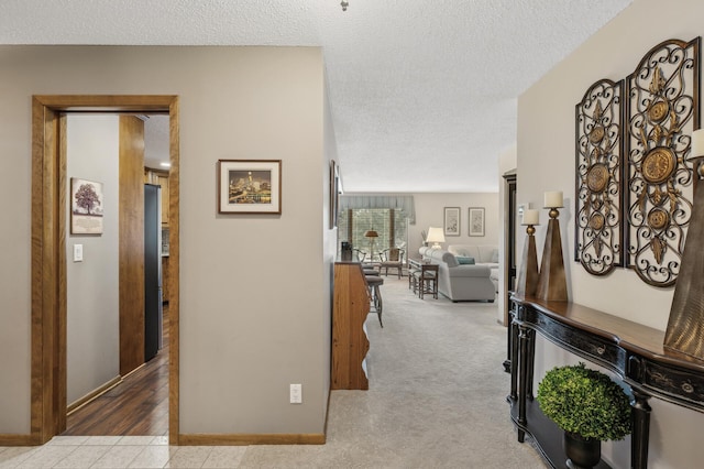 hall featuring a textured ceiling