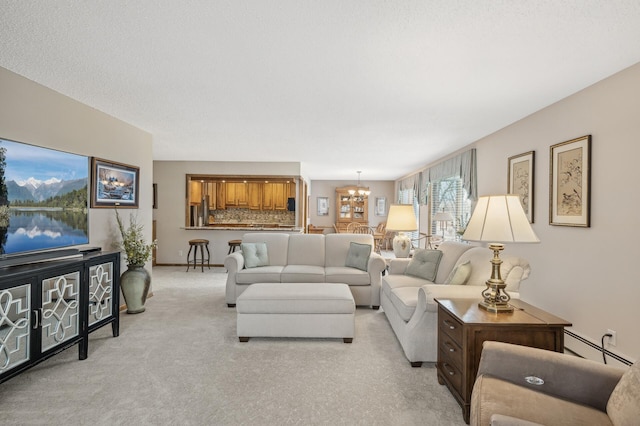 carpeted living room with a notable chandelier and baseboard heating