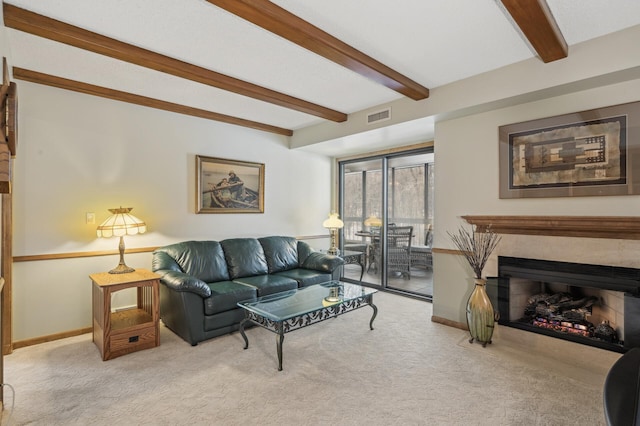 carpeted living room featuring beamed ceiling