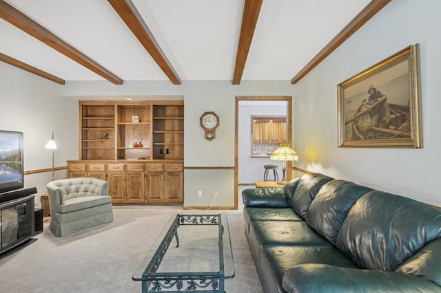 living room with beamed ceiling and light carpet