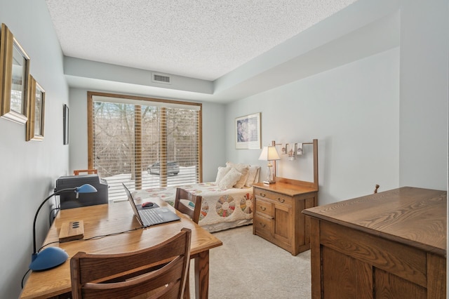 carpeted home office with a textured ceiling