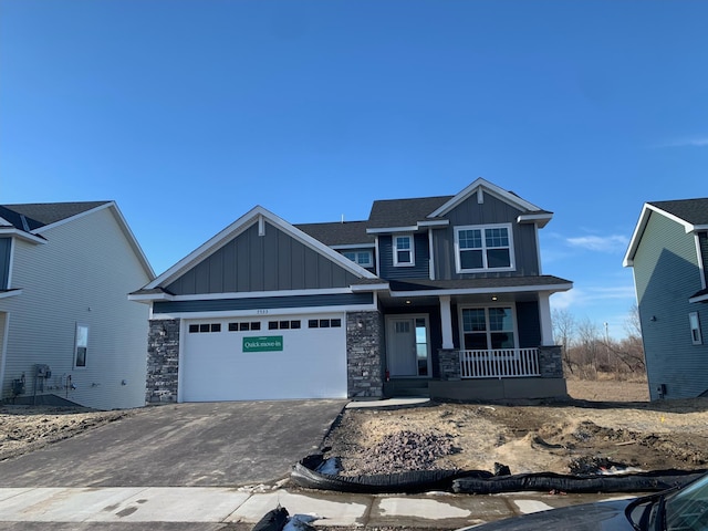 view of front of property featuring a garage and a porch