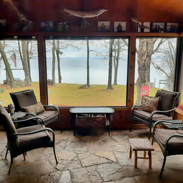 sunroom / solarium with a water view and a wealth of natural light