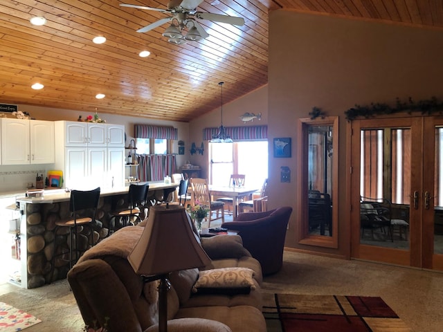 carpeted living room featuring ceiling fan, lofted ceiling, and wooden ceiling