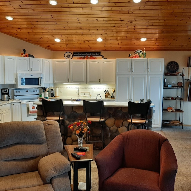 living room featuring vaulted ceiling, light carpet, and wooden ceiling