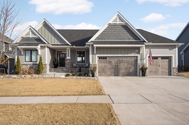 craftsman-style house featuring a porch, a garage, and a front yard