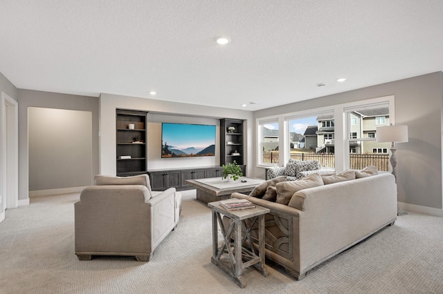 carpeted living room featuring a textured ceiling