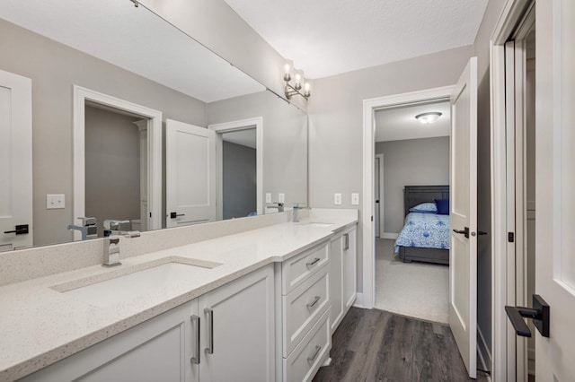 bathroom with vanity, hardwood / wood-style floors, and a textured ceiling