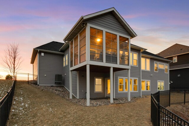rear view of property featuring cooling unit and a fenced backyard