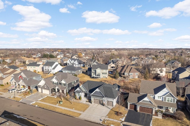 aerial view of property and surrounding area featuring nearby suburban area