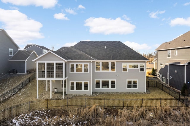 rear view of house featuring a sunroom and cooling unit