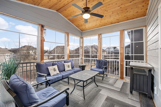 sunroom / solarium featuring an outdoor hangout area, vaulted ceiling, a ceiling fan, and healthy amount of natural light