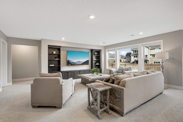 living room with light carpet, baseboards, recessed lighting, built in shelves, and a textured ceiling