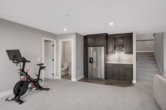 workout room with bar with sink, baseboards, carpet floors, and recessed lighting