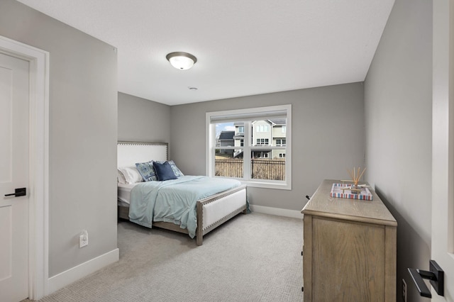 carpeted bedroom with baseboards