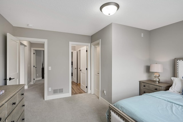bedroom featuring light carpet and baseboards