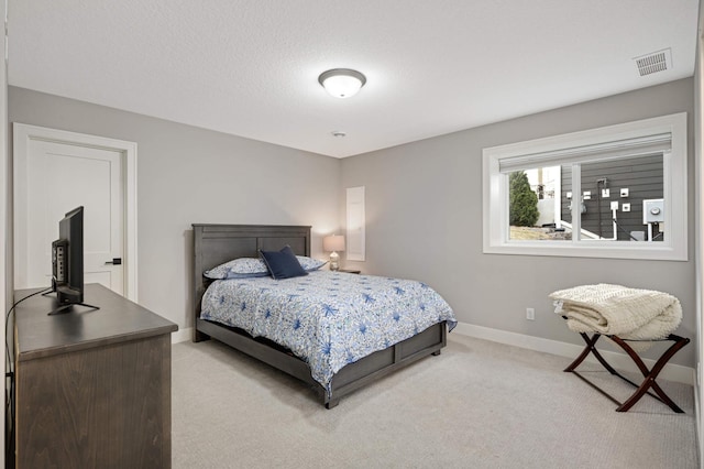 bedroom with light carpet and baseboards