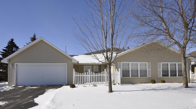 ranch-style home featuring an attached garage and fence