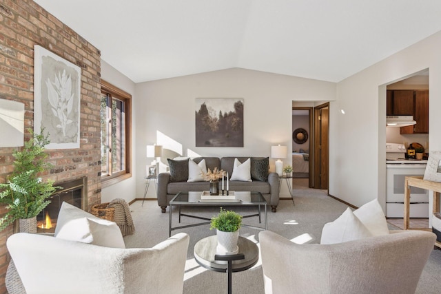 carpeted living room with a brick fireplace and vaulted ceiling