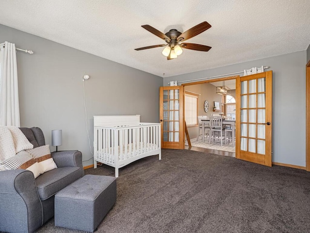 carpeted bedroom featuring french doors, ceiling fan, and a textured ceiling