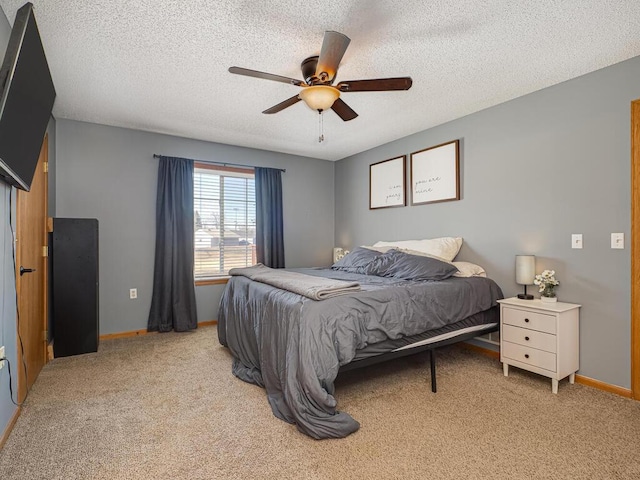 carpeted bedroom with a textured ceiling and ceiling fan