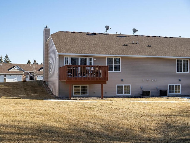 back of property with cooling unit, a yard, and a deck