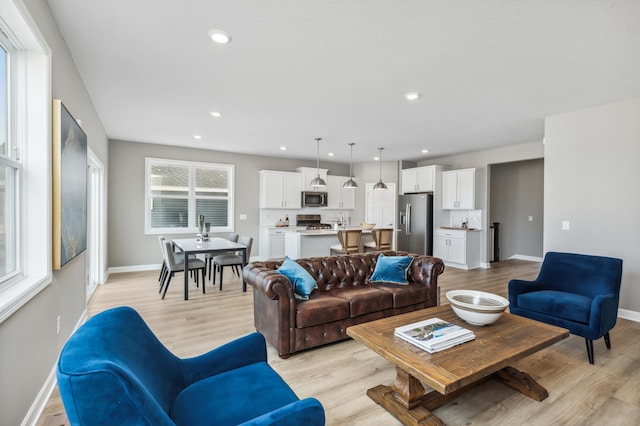 living room with light hardwood / wood-style floors and a wealth of natural light