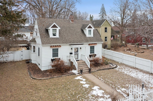 view of front of home featuring a shingled roof, a gate, and fence