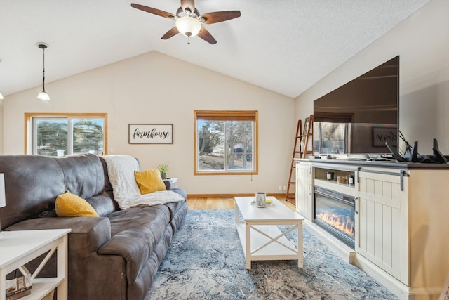 living room featuring hardwood / wood-style floors, vaulted ceiling, and ceiling fan