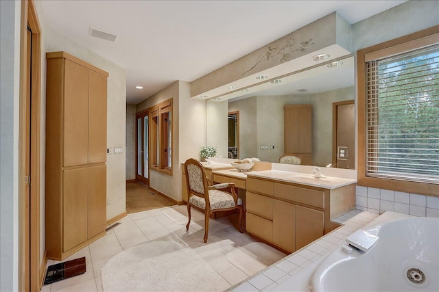 bathroom featuring vanity, a bathtub, and tile patterned floors