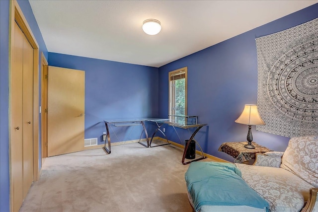 sitting room featuring light colored carpet