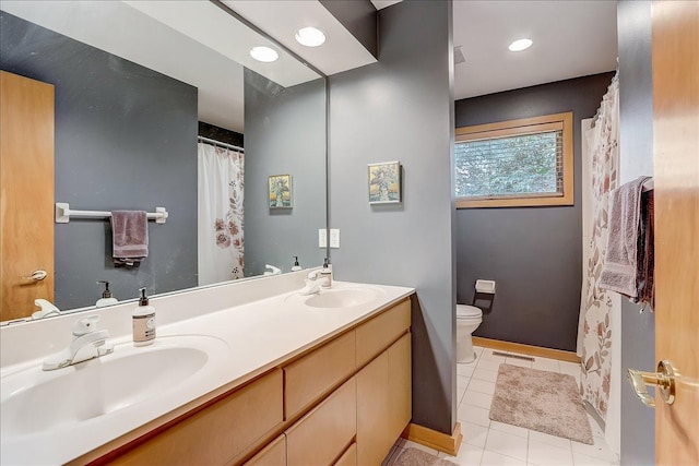 bathroom featuring vanity, tile patterned flooring, and toilet