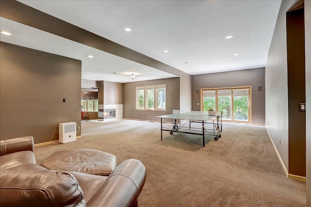 recreation room featuring light carpet