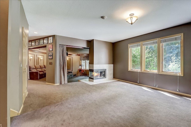 unfurnished living room featuring light carpet and a fireplace