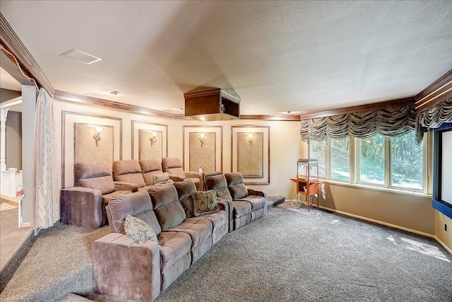 carpeted home theater with ornamental molding and a textured ceiling