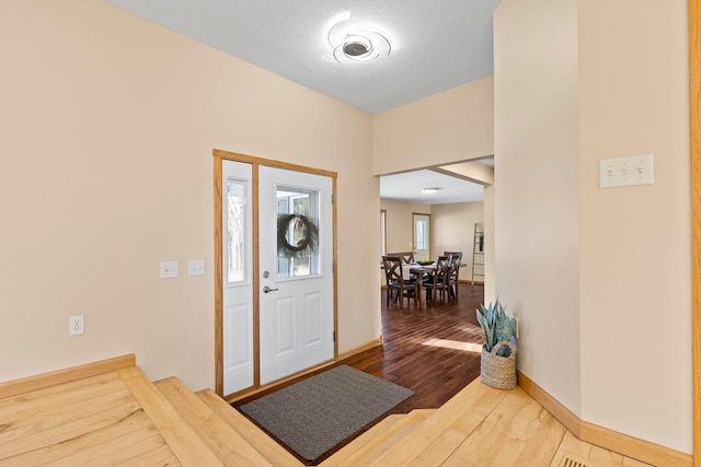 entrance foyer featuring wood-type flooring and a textured ceiling