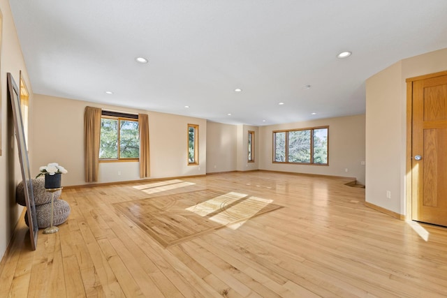 unfurnished living room with a wealth of natural light and light wood-type flooring