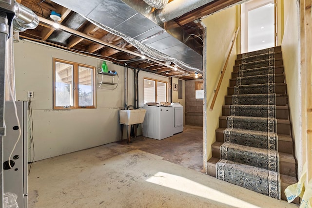 basement featuring sink and independent washer and dryer