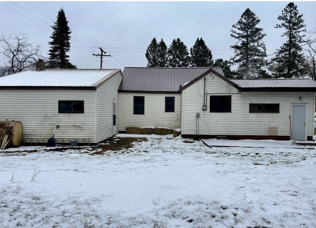 view of snow covered rear of property