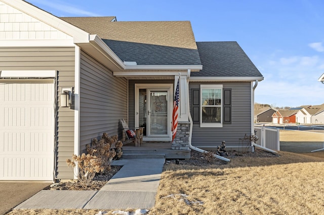 view of front of property with a garage and a front lawn