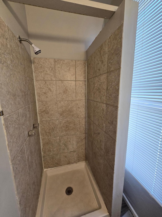 bathroom with a tile shower