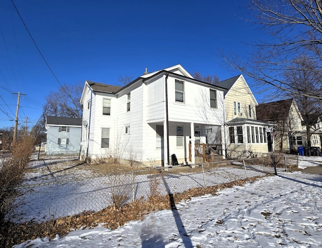 view of snow covered back of property